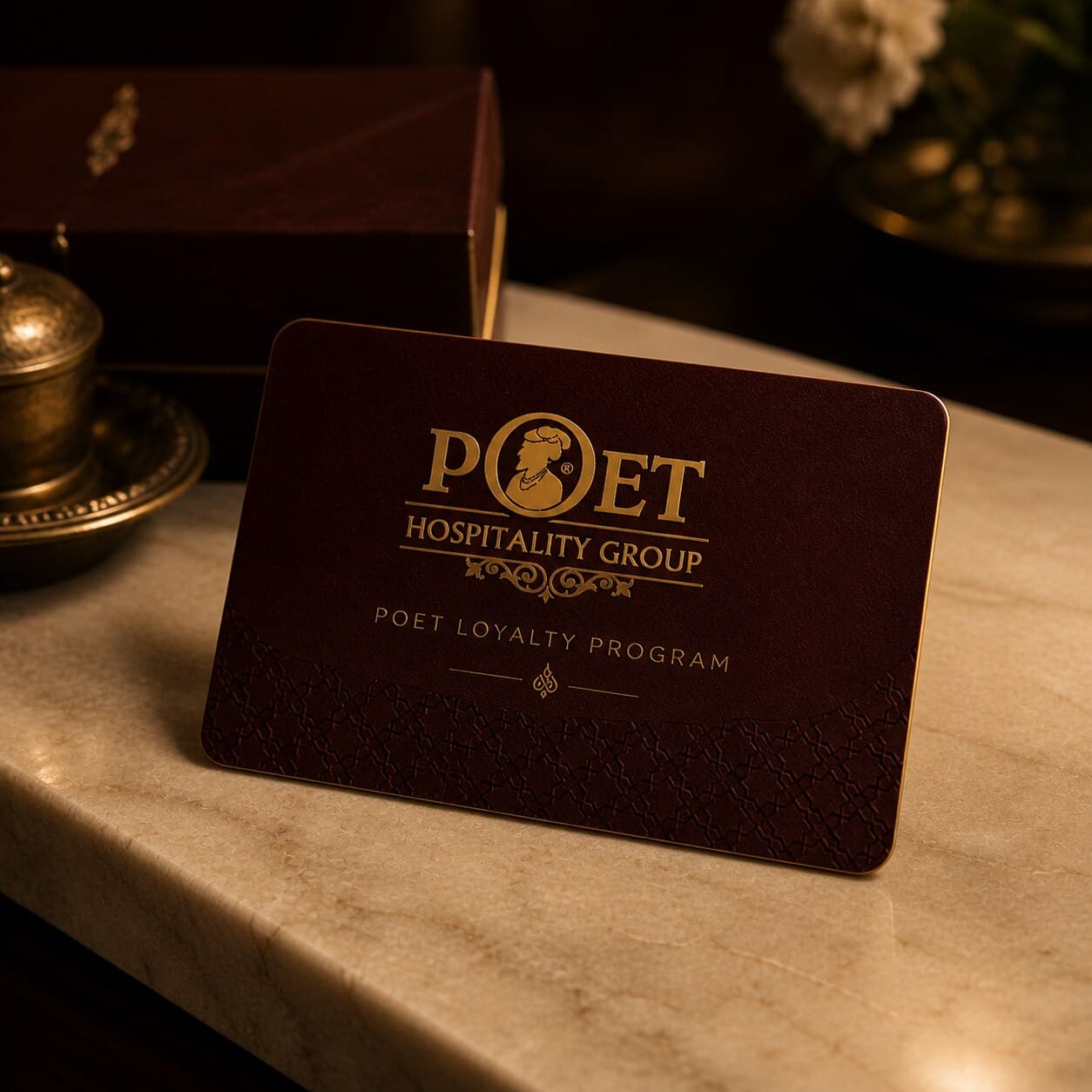 Editorial photograph of the Poet Loyalty card resting on warm cream marble